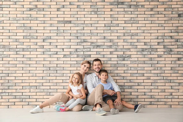 Lycklig familj sitter på golvet i tom Lägenhet — Stockfoto