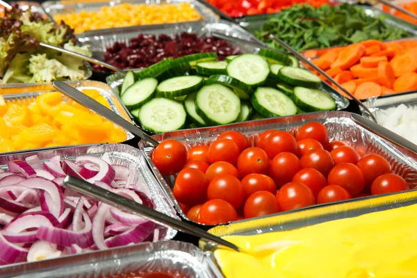 Close up of salad bar with assortment of ingredients