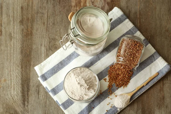 Glass Jars Buckwheat Flour Raw Grains Wooden Background — Stock Photo, Image