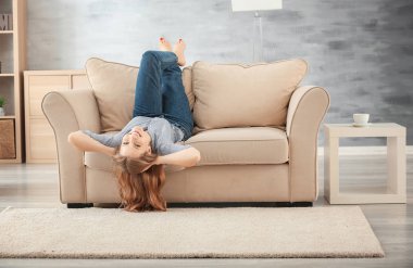 Güzel kadın evde koltukta dinleniyor