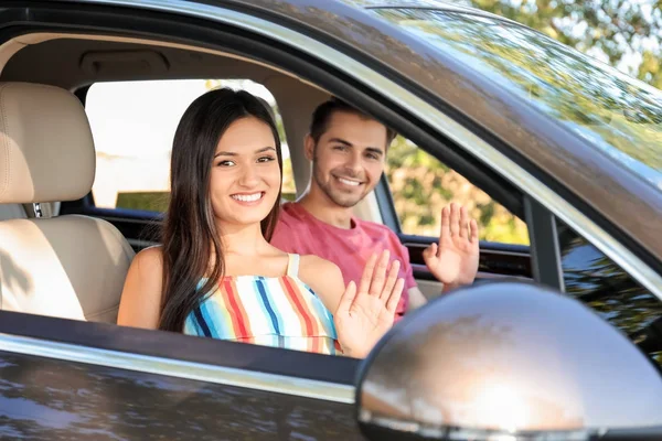 Beautiful young couple in car — Stock Photo, Image