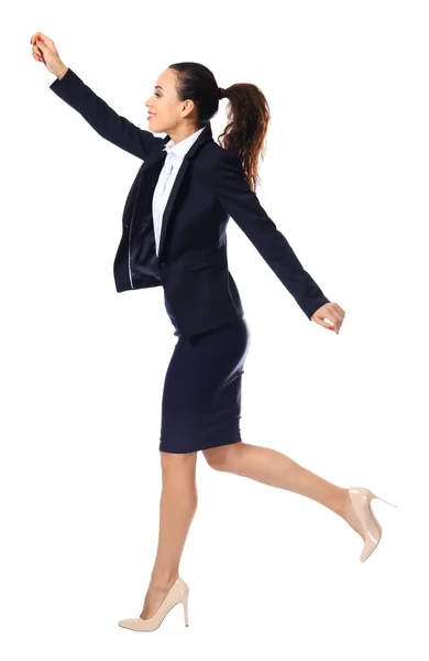 Young woman in formal clothes running against white background — Stock Photo, Image