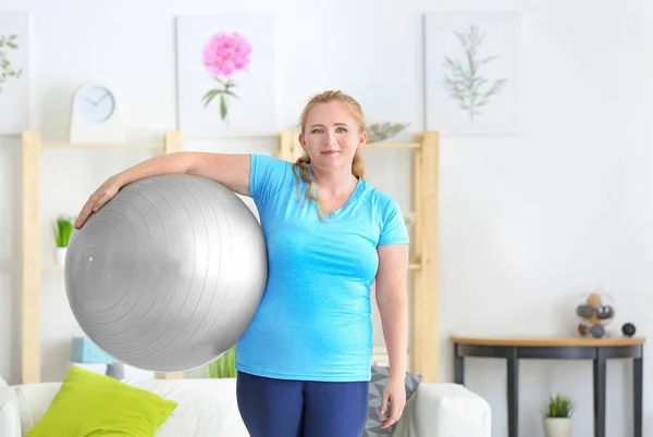 Overweight woman with fitness ball — Stock Photo, Image