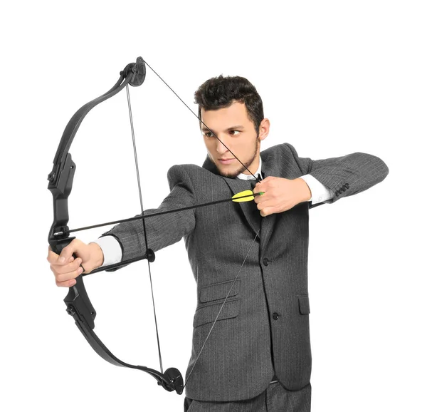 Young businessman practicing archery on white background — Stock Photo, Image