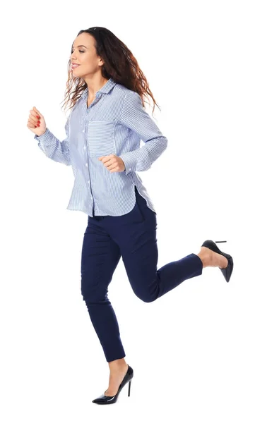 Young woman in casual clothes running against white background — Stock Photo, Image