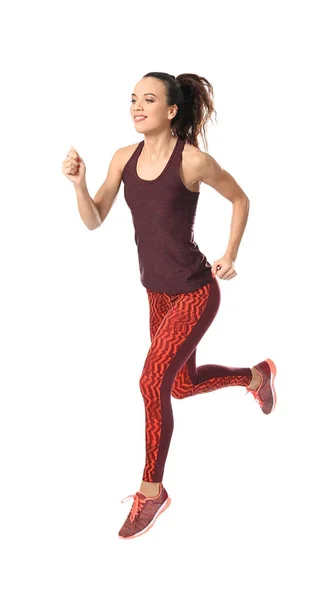 Mujer joven en ropa deportiva corriendo sobre fondo blanco — Foto de Stock