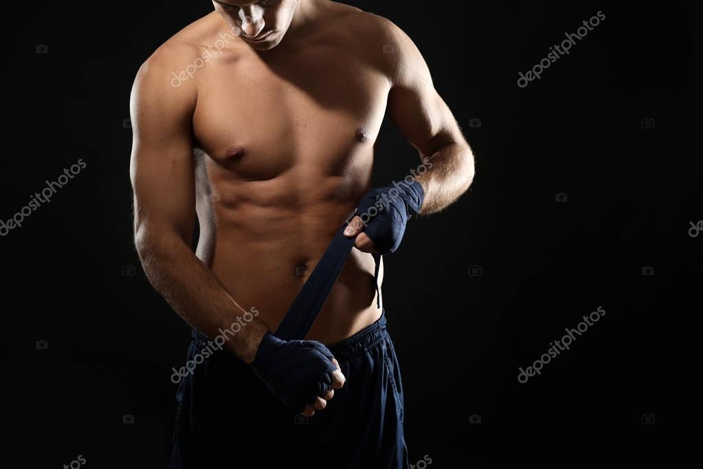 Male boxer applying wrist wraps — Stock Photo © belchonock 177926238