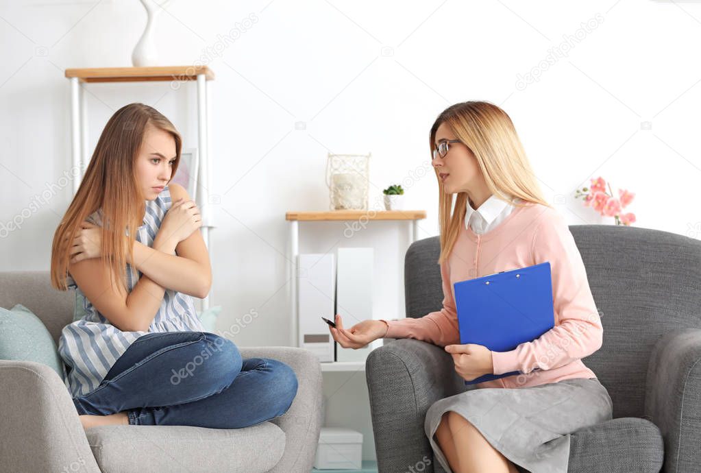 Psychologist working with young woman 