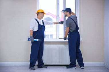 İnşaat işçisi stajyer pencere içinde ev yükleme ile