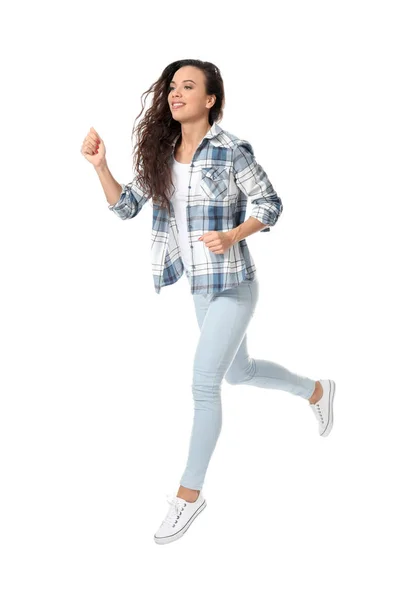 Junge Frau in legerer Kleidung läuft vor weißem Hintergrund — Stockfoto