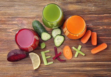 Malzemeler ve gözlük tablosundaki çeşitli taze meyve suları ile yapılmış Word Detoks