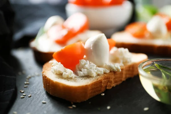 Delicious sandwich with cherry tomato and mozzarella on table, closeup — Stock Photo, Image