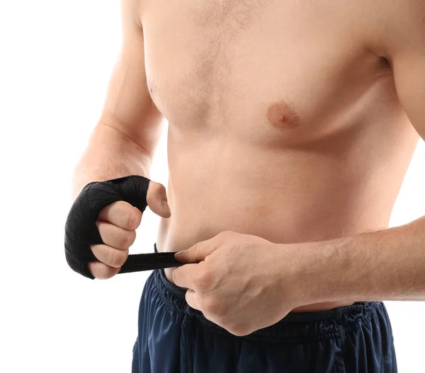 Male boxer applying wrist wraps