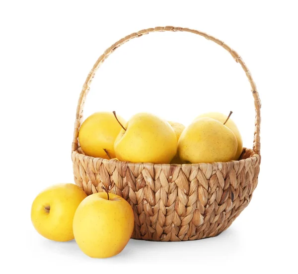 Wicker basket with ripe yellow apples on white background — Stock Photo, Image