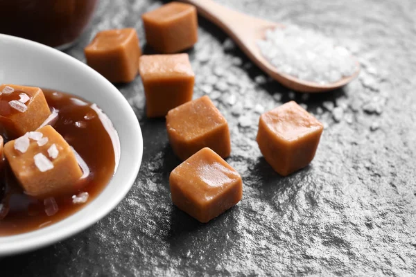 Composition with tasty caramel candies on table — Stock Photo, Image