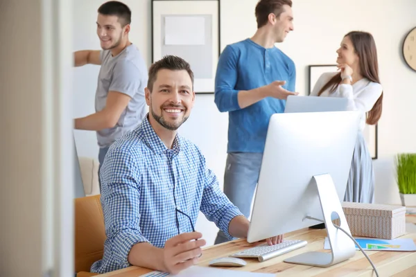 Group of young professionals having meeting in office