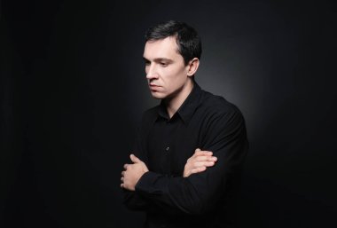 Siyah arka plan üzerine ciddi genç adam