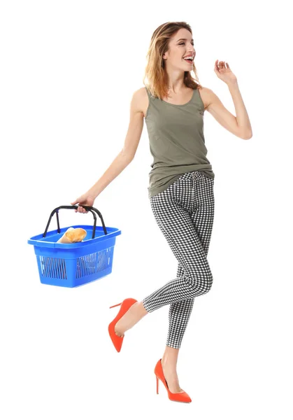 Young woman holding shopping basket with groceries on white background — Stock Photo, Image