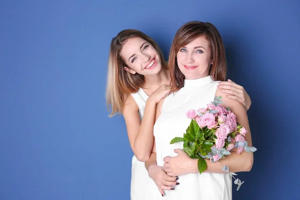 Aantrekkelijke Jonge Vrouw Met Haar Moeder Bijpassende Jurken Kleur Achtergrond — Stockfoto