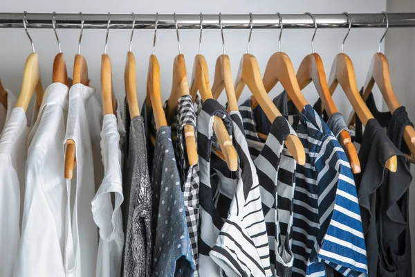 Female clothes on hangers in wardrobe — Stockfoto