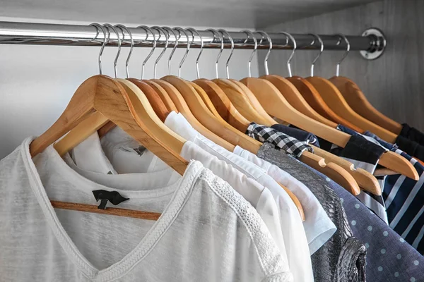 Female clothes on hangers in wardrobe — Stok fotoğraf