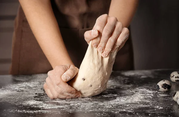 Frau knetet Teig auf Tisch — Stockfoto