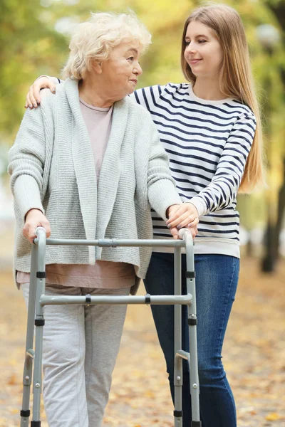 Young Woman Her Elderly Grandmother Walking Frame Autumn Park — Stock Photo, Image