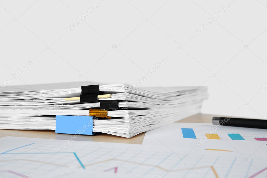 Stack of documents on table against light background