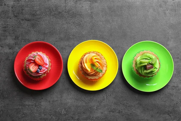 Plates with tasty colorful cakes on table, top view — Stock Photo, Image