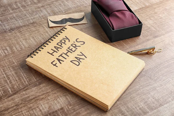 Necktie and notebook on wooden background. Father's day composition — Stock Photo, Image