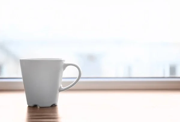 Ceramic cup on window sill — Stock Photo, Image