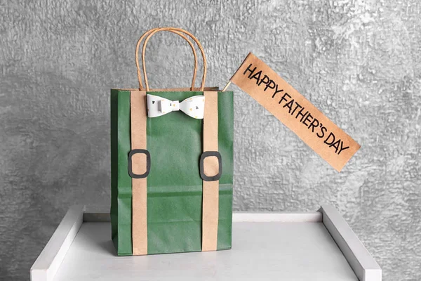 Paper bag with gift for Father\'s day on table