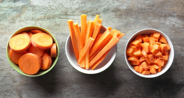 Bowls with cut carrot — Stock Photo, Image