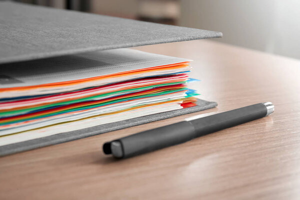Folder with documents on table