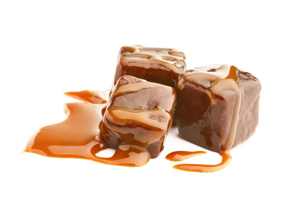 Delicious candies with caramel sauce — Stock Photo, Image