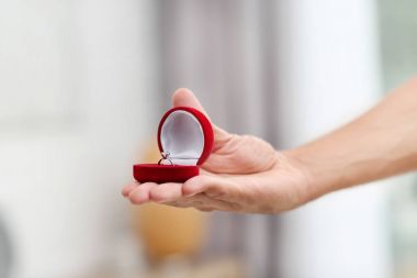 Adam arka plan bulanık nişan yüzüğü kutusuyla holding