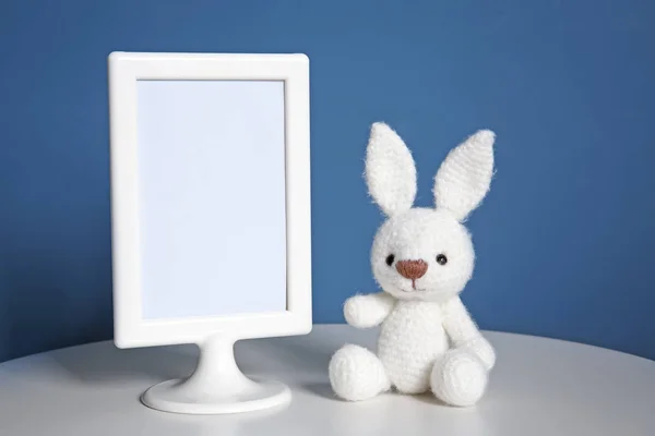 Mockup of blank frame with toy on color background — Stock Photo, Image