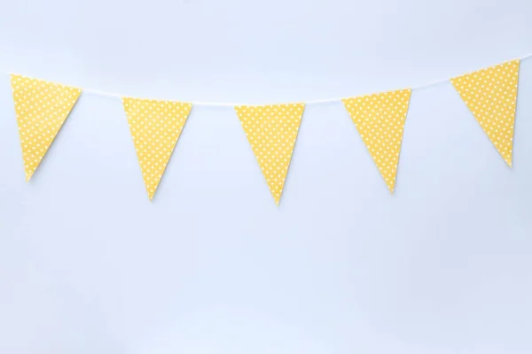 Handmade yellow garland on light wall — Stock Photo, Image