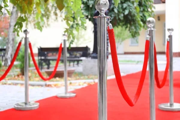 Rope barrier on red carpet, outdoors — Stock Photo, Image