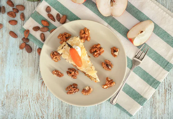 Piece of tasty carrot cake on wooden table — Stock Photo, Image