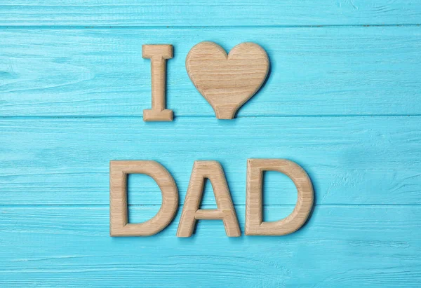 Composition with phrase I LOVE DAD for Father's Day on wooden background — Stock Photo, Image