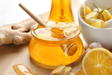 Composition with honey, ginger and garlic on table, closeup clipart