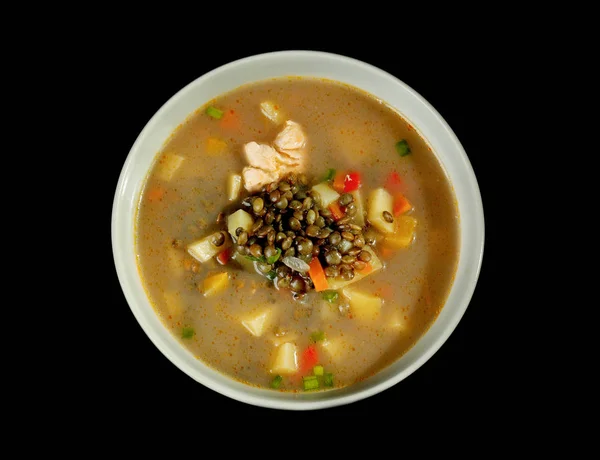 Bowl with tasty lentil soup on black background — Stock Photo, Image