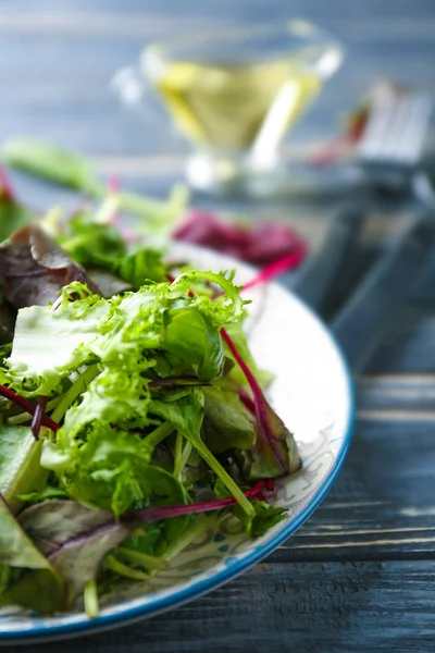 Plate of fresh salad on wooden table, closeup — Stock Photo, Image