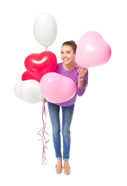 Junge Frau mit herzförmigen Luftballons — Stockfoto