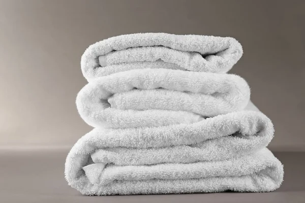 Stack of soft terry towels on grey background — Stock Photo, Image