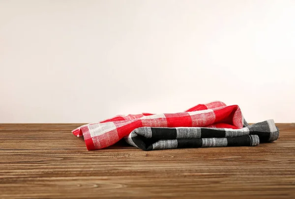 Clean kitchen towels on table against light background — Stock Photo, Image