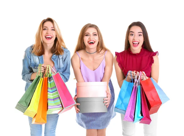 Happy young women with shopping bags and boxes on white background — Stock Photo, Image