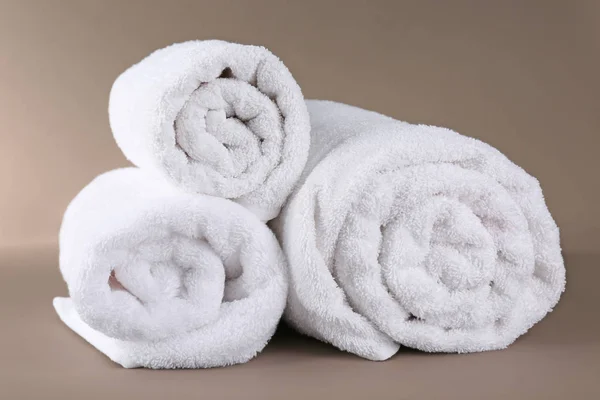 Rolled terry towels on color background — Stock Photo, Image