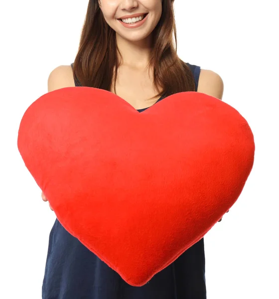 Romantic young woman with heart-shaped pillow on white background — Stock Photo, Image